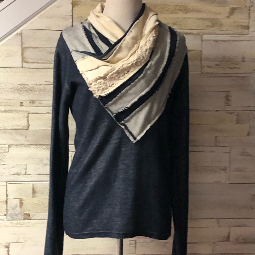 Blue sweater with cute prints at top.